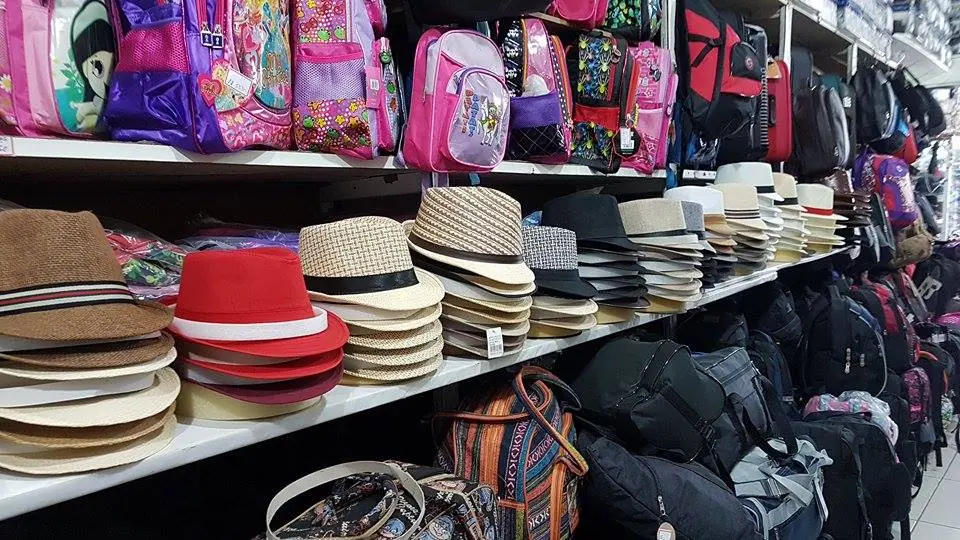 Prateleiras com chapéus de palha e mochilas
